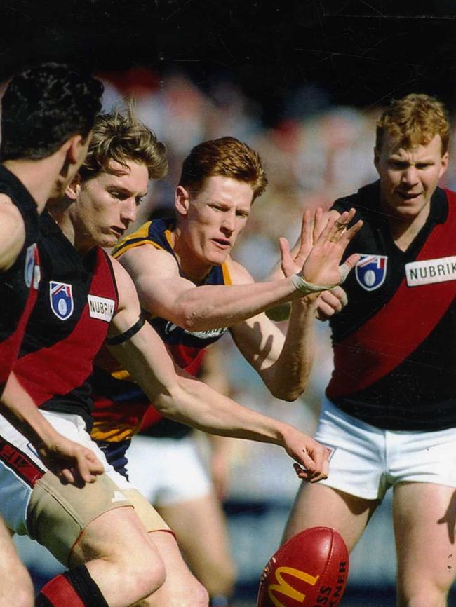 James Hird and Darren Bewick with Adelaide’s Ben Hart in a clash between The Crows and Essendon at the MCG in 1993. Photo: David Geraghty.