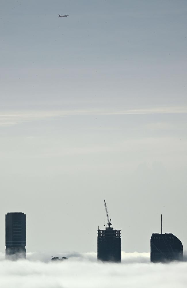 A plane takes off during this morning’s fog. Picture: Lyndon Mechielsen