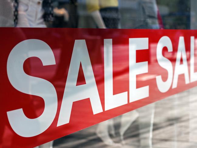 Picture of shop window display with text Sale on red poster