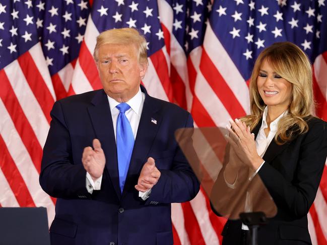 Donald Trump and first lady Melania Trump take the stage in the East Room of the White House to declare an early victory. Picture: Getty