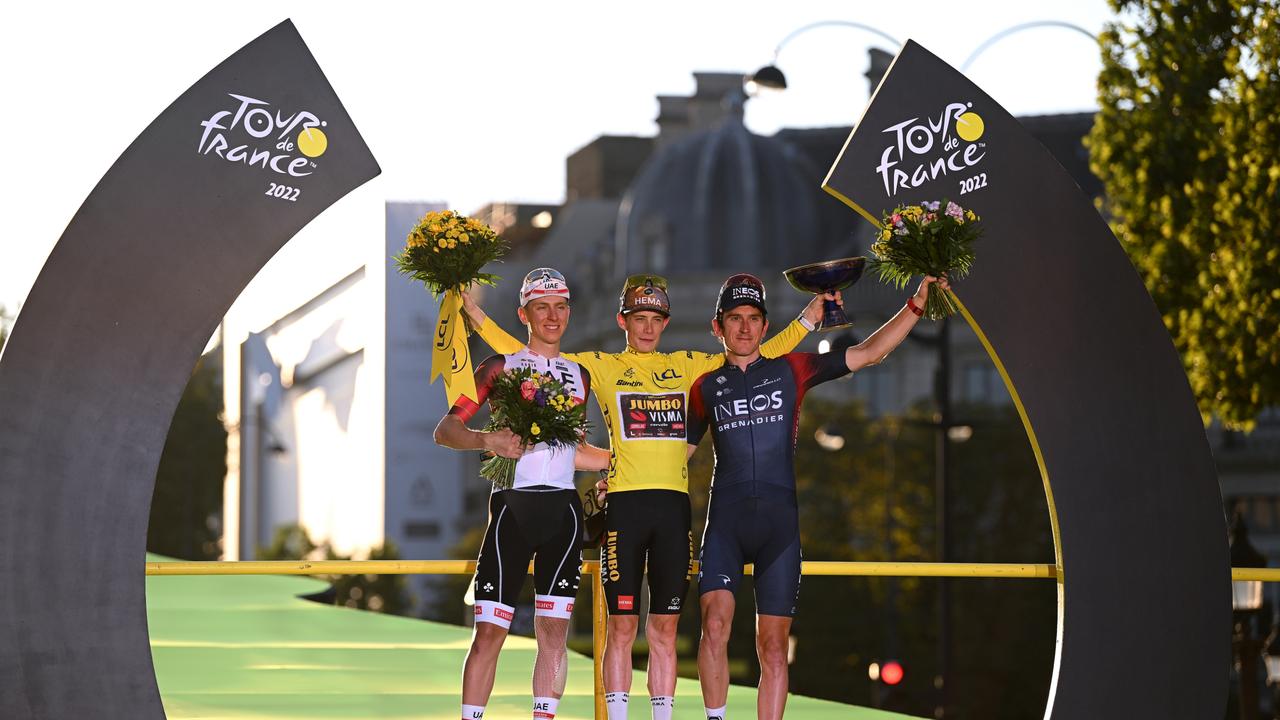 Jonas Vingegaard Rasmussen of Denmark and Team Jumbo – Visma (C) celebrates his Tour de France win alongside the runners-up.