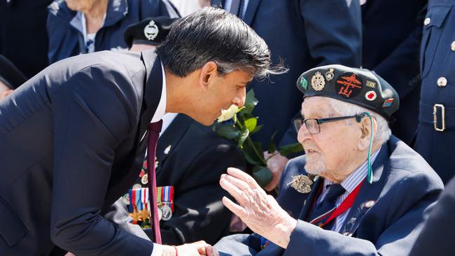 Britain's Prime Minister Rishi Sunak meets with a British D-Day veteran during the commemorative ceremony marking the 80th anniversary of D-Day.