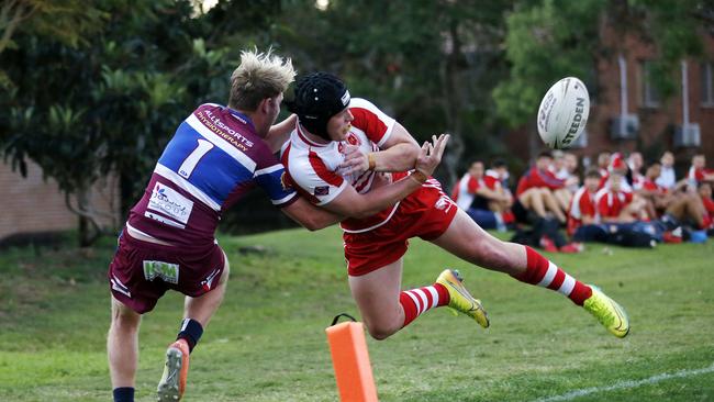 Corey Thomas pulls Palm Beach Currumbin player Smith over the sideline last year. (Image/Josh Woning)