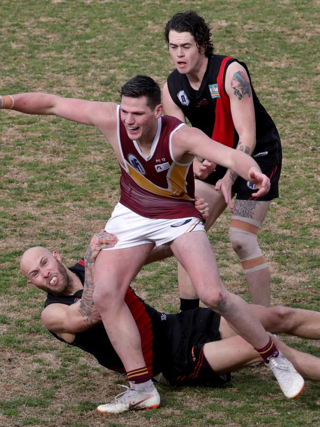 Brent Macaffer takes a hold of a Lower Plenty opponent during the NFL Division 2 grand final.