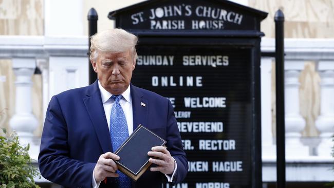 President Donald Trump holds a Bible as he visits outside St John's Church across Lafayette Park from the White House.