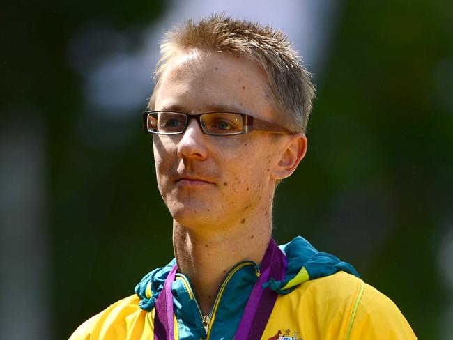 Australia's Jared Tallent listens to his national anthem as he poses on the podium with his silver medal after the London 2012 Olympic Games Men's 50km race walk in central London on August 11, 2012. AFP PHOTO / FRANCK FIFE