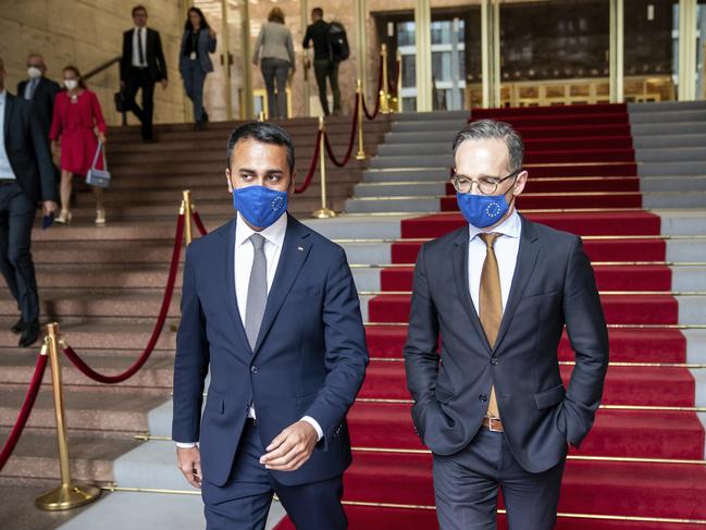 The WHO recommends that mask-wearing be more widely adopted. German Foreign Minister Heiko Maas, right, and his Italian counterpart Luigi Di Maio wear face masks. Picture: AP