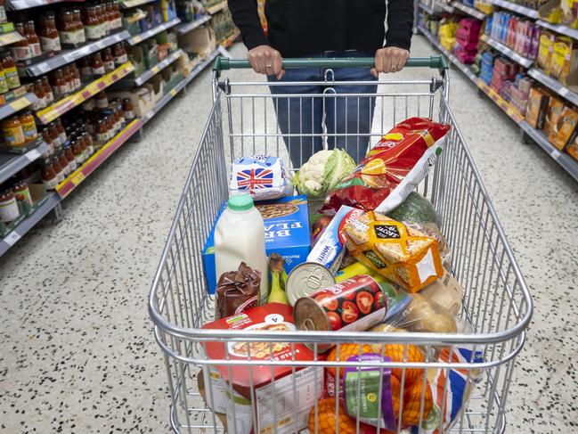 CARDIFF, WALES - MAY 22: A woman with a shopping trolley full of groceries in a supermarket aisle on May 22, 2022 in Cardiff, Wales. Last week, the UK Office for National Statistics reported an 6% average increase of food and drink prices year on year, but some staples, such as milk and pasta, had risen by more than 10%. (Photo by Matthew Horwood/Getty Images)