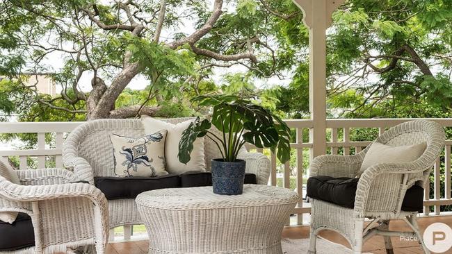 The home is a classic Queenslander with wraparound veranda.