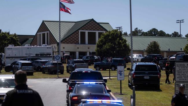 Police swarmed the scene at the school. Picture: Christian Monterossa/AFP