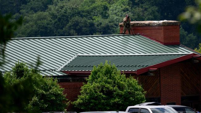 A Pennsylvania State Police sniper scans the parking lot at Laube Hall in the Freeport Community Park. Picture: Getty Images via AFP.