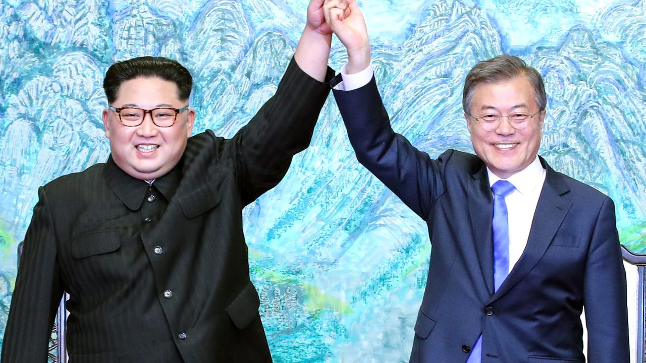 Here he is smiling with South Korean President Moon Jae-in. Picture: Getty Images