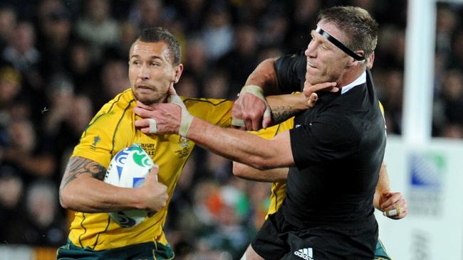 Wallabies Quade Cooper (L) is tackled All Blacks Brad Thorn during New Zealand v Australia 2011 Rugby World Cup (RWC) semi-final match at Eden Park Stadium in Auckland, 16/10/2011.