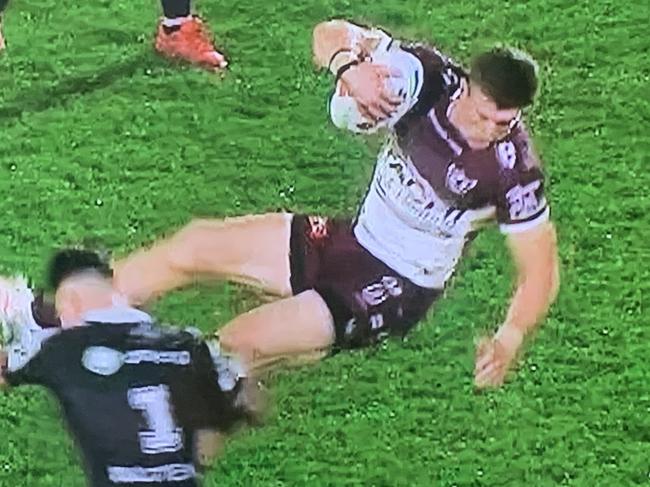 Manly’s Reuben Garrick is tackled in mid-air by NZ Warriors fullback Charnze Nikoll-Klokstad in Auckland last night.