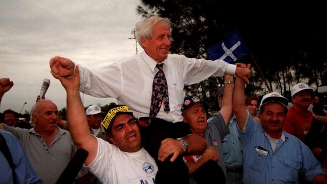 Then MUA secretary John Coombs being held aloft by workers at Port Botany after Federal Court decision that Patrick Stevedores should re-employ sacked wharfies.