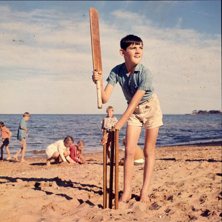 1971 - Mervyn Wigg, 12, of Tara prepares for a great Aussie tradition of beach cricket. Picture: Ted Holliday.