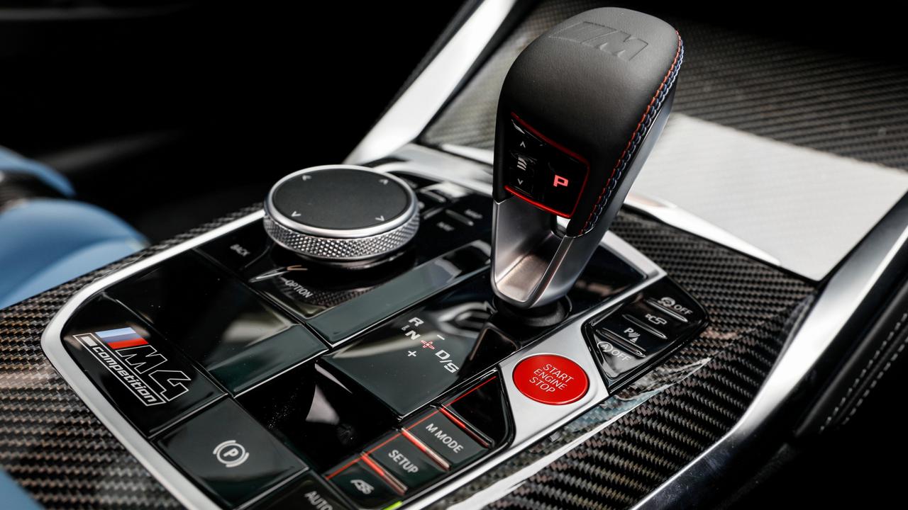 Console buttons enhance or dial down the performance of the BMW M4 Competition Convertible.