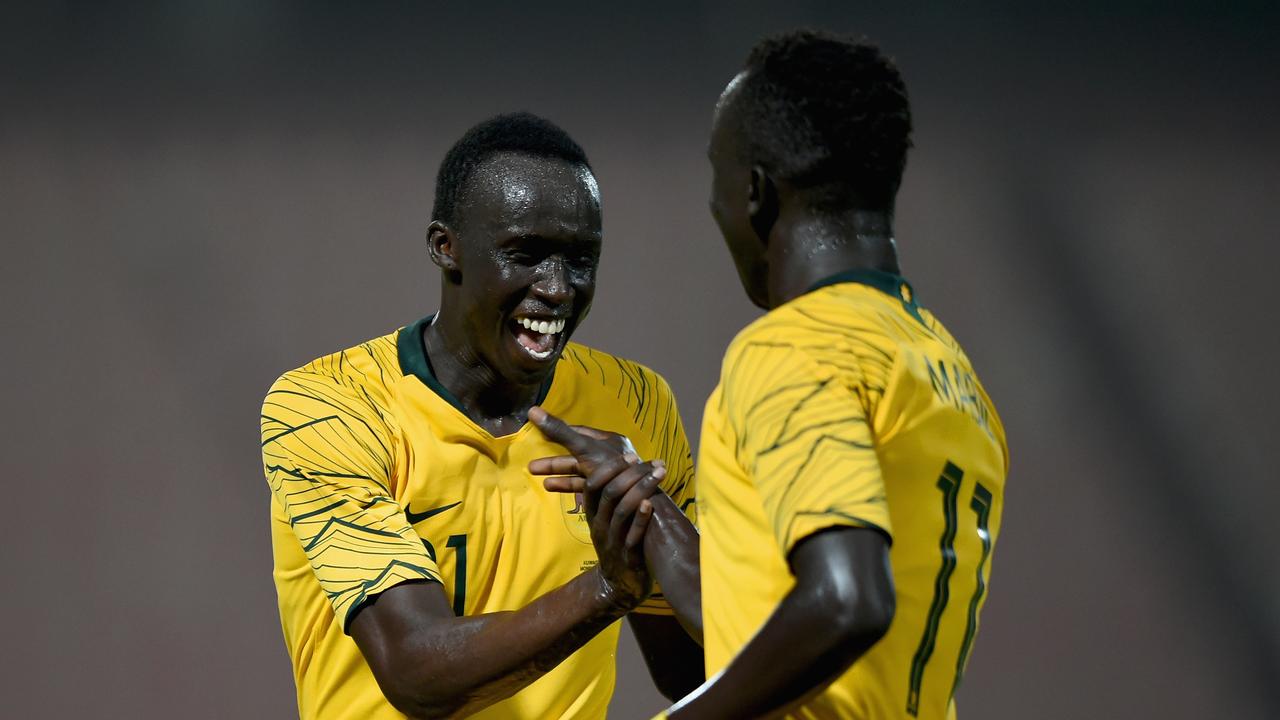 Awer Mabil (R) of Australia celebrates with Thomas Deng (L) scoring his sides fourth goal