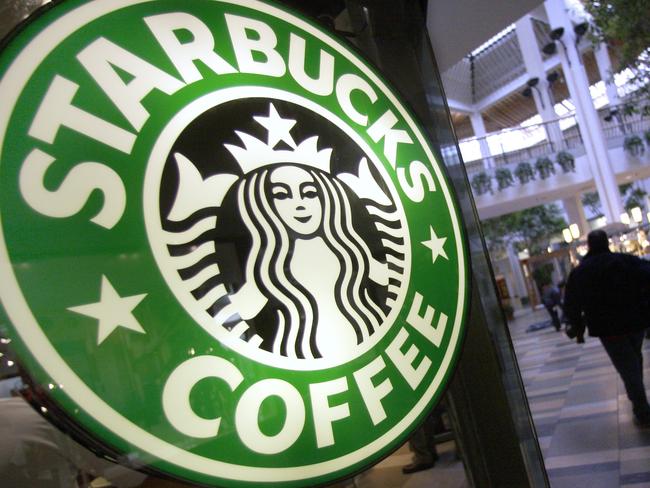 A man pulls a cart past Starbucks coffe store inside the Beachwood Mall in Beachwood, Ohio, 10/11/2008.