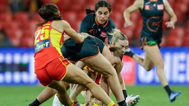 Giant Jessica Doyle and Gold Coast’s Elise Barwick clash heads in the opening minute of the game on Friday night. Picture: Russell Freeman/AFL Photos