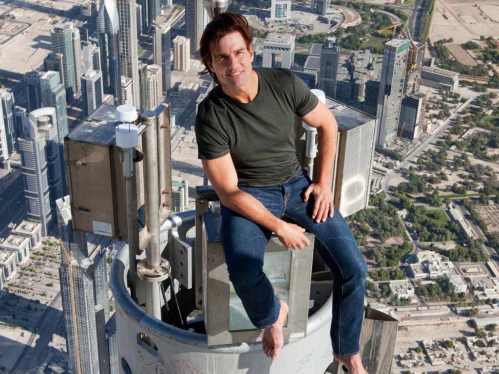 Tom Cruise sitting atop the Burj Khalifa, after climbing the 828 metre skyscraper to film a stunt for one of his movies.
