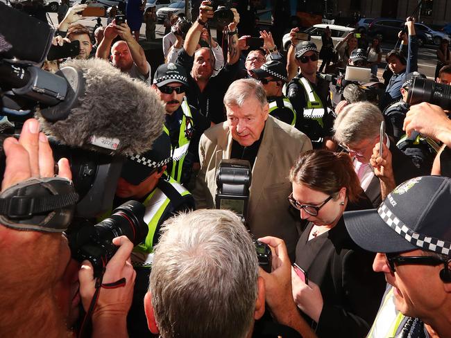 Media swarm George Pell as he arrives at Melbourne Magistrates’ Court in 2019. Picture: Getty