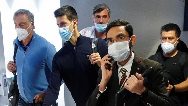 Serbian tennis player Novak Djokovic walks with his team after landing at Dubai Airport Photo: Reuters.