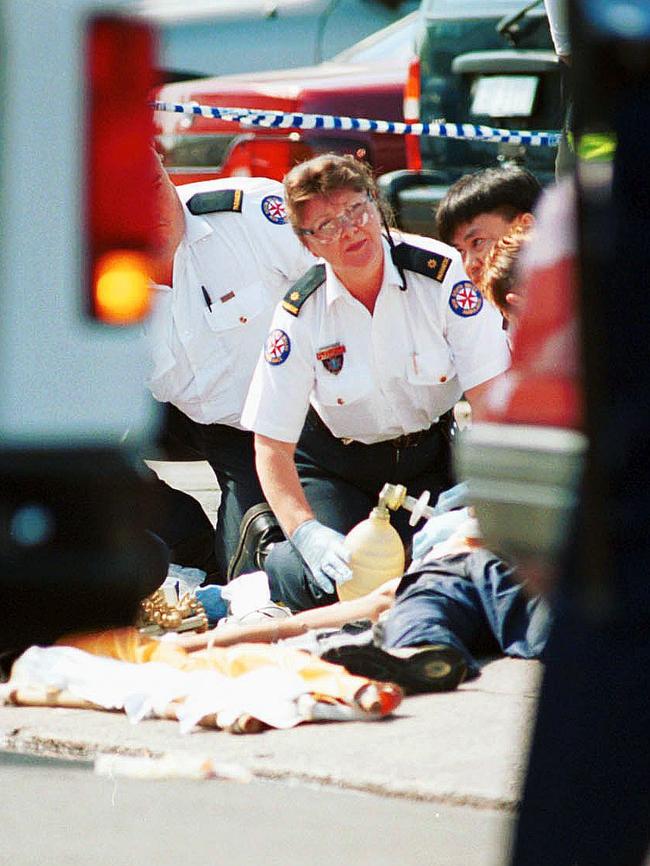 Paramedics attempt to save a man stabbed on Arthur Street, Cabramatta in February 2000. He later died on the way to hospital. Picture: Dean Marzolla 