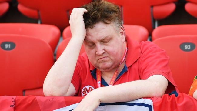 An Adelaide United fan feels the heat during the Reds’ A-League clash with Newcastle Jets at Hindmarsh Stadium. Picture: Mark Brake/Getty Images