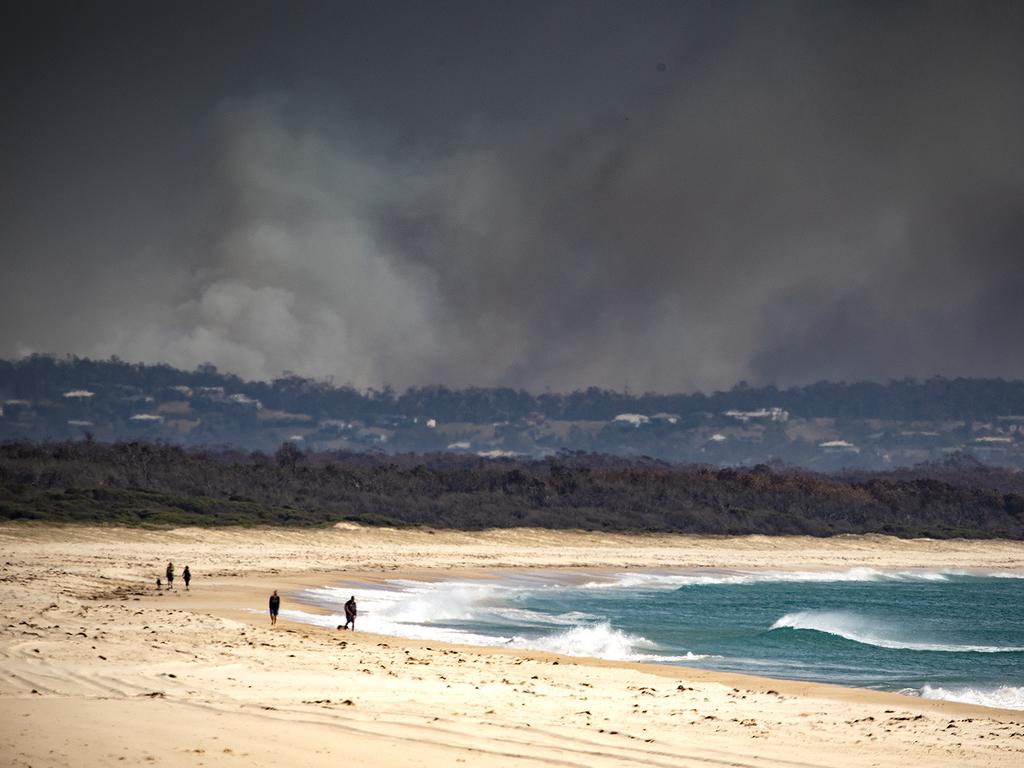 Smoke is seen in the distance near Tuncurry, NSW, November 9, 2019. Picture: AAP Image/Shane Chalker