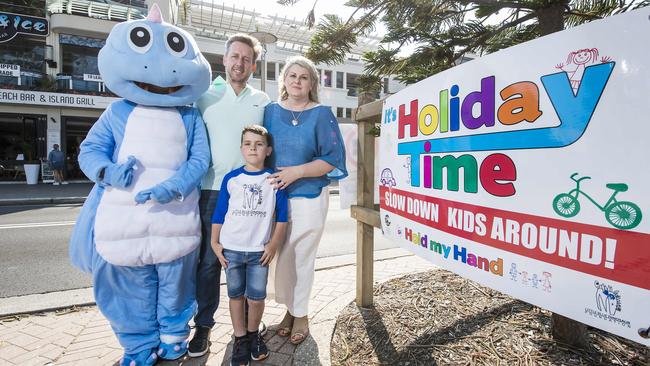 The Little Blue Dinosaur, David and Michelle McLaughlin and their son Hugh, 7, want motorists to slow down while kids are around during the holiday season on the northern beaches. Picture: Troy Snook