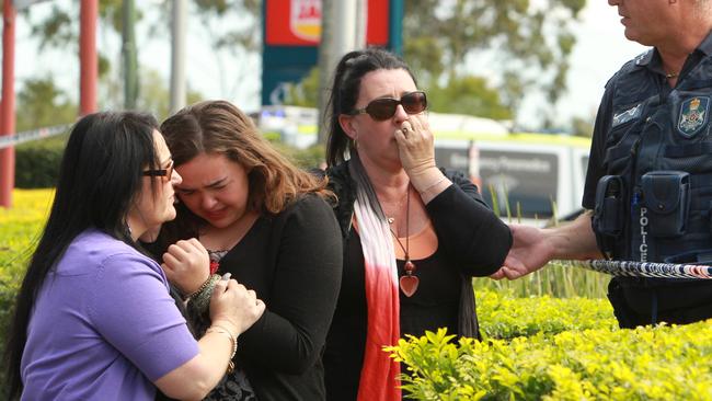 Sgt John Kaz consoles a woman at the scene. Photo Mike Batterham