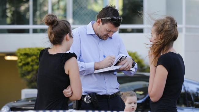 Police officers talking to residents at the scene. Picture: Williams Jerad