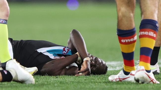 ADELAIDE, AUSTRALIA - JULY 29: Aliir Aliir of the Power on the ground along with Lachie Jones of the Power after they collided during the 2023 AFL Round 20 match between the Adelaide Crows and the Port Adelaide Power at Adelaide Oval on July 29, 2023 in Adelaide, Australia. (Photo by Sarah Reed/AFL Photos via Getty Images)