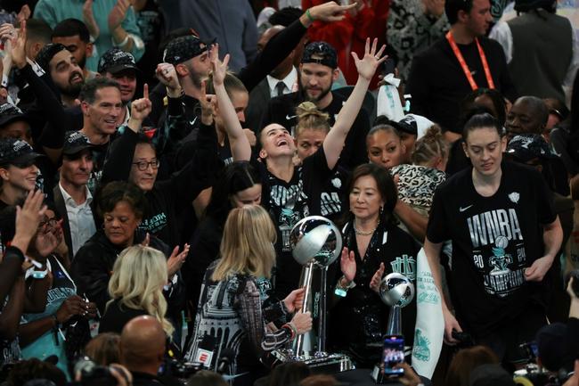 WNBA commissioner Cathy Engelbert, at center front presenting the championship trophy to the New York Liberty, will now enter talks on a new collective bargaining deal after the players union opted out of their current deal, which lasts through the 2025 season