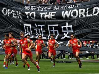 Suns and Port players run on to Jiangwan Stadium, Shanghai on May 14, 2017. Picture: Tracey Nearmy/AAP