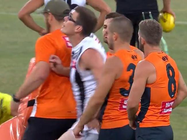 Pies ruckman Mason Cox - public enemy No.1 at GWS - runs through the Giants ruck warm-up and takes the ball