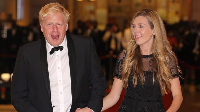 Boris Johnson and Carrie Johnson put on a brave face as they arrive at the Commonwealth Heads of Government Dinner at the Marriott Hotel in Kigali, Rwanda. Picture: Getty Images