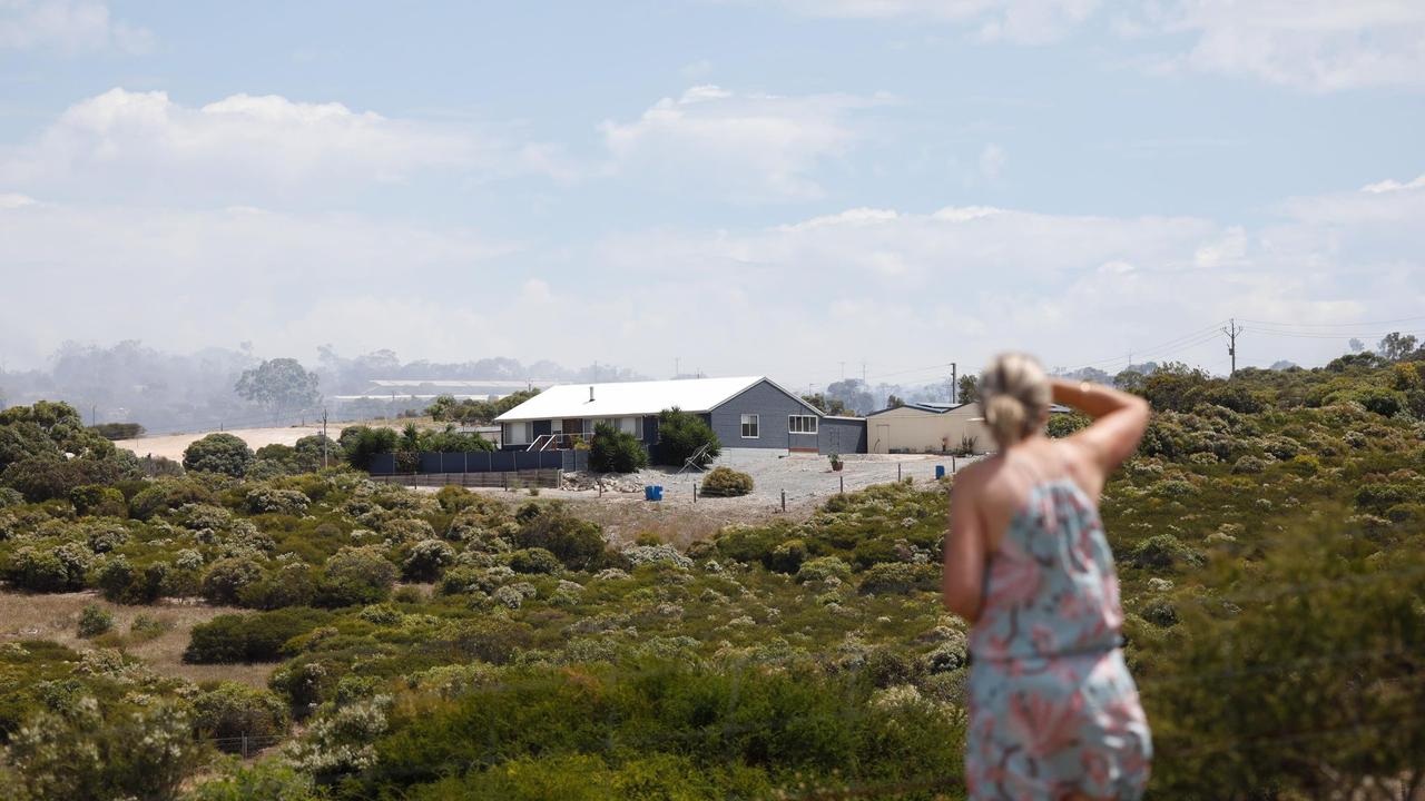 . Sam Cope watches as the fire approaches her home, which was saved by her neighbours. Picture: Robert Lang