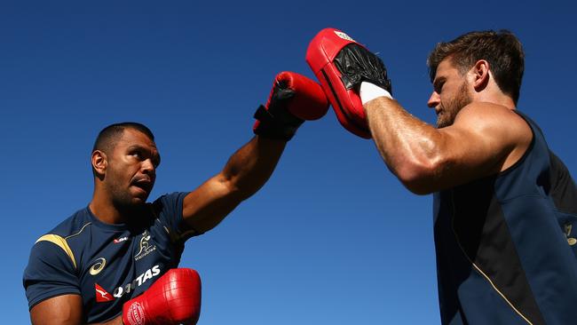 Kurtley Beale of the Wallabies boxes with Rob Horne.