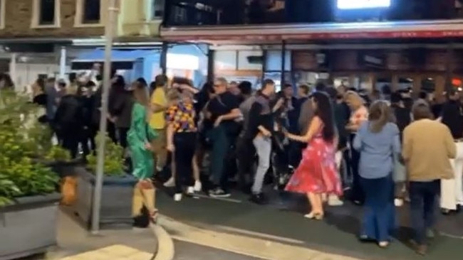 A large group of people dancing in Rundle Street – before the police arrived and shut it down, fining Sugar nightclub in the process for breaching anti-dancing Covid rules.