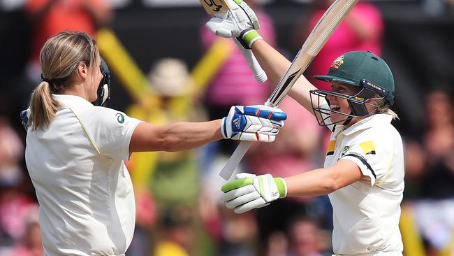 Perry celebrates her century with Alyssa Healy. Picture. Phil Hillyard