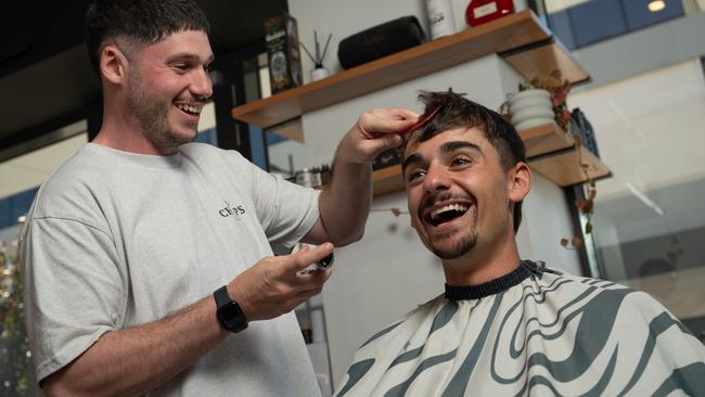 Barber Grant Freedman is undertaking a 24-hour challenge in April to raise money for The Shaka Project, pictured with client Sam Limbris. Picture: Naomi Jellicoe