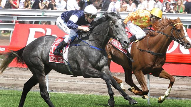 Michael Rodd (left) winning the 2007 Melbourne Cup aboard Efficient. Picture: News Corp Australia.