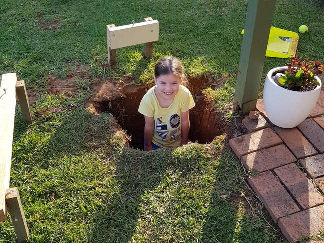 Matt Carman dug a whole for stormwater and checked the depth by putting daughter Lil in the hole (done safely of course). Picture: Supplied