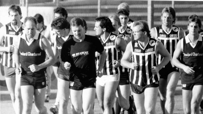 The Port Adelaide team on the run with coach John Cahill (far left) 01 Oct 1990. (Pic by staff photographer Ray Titus)