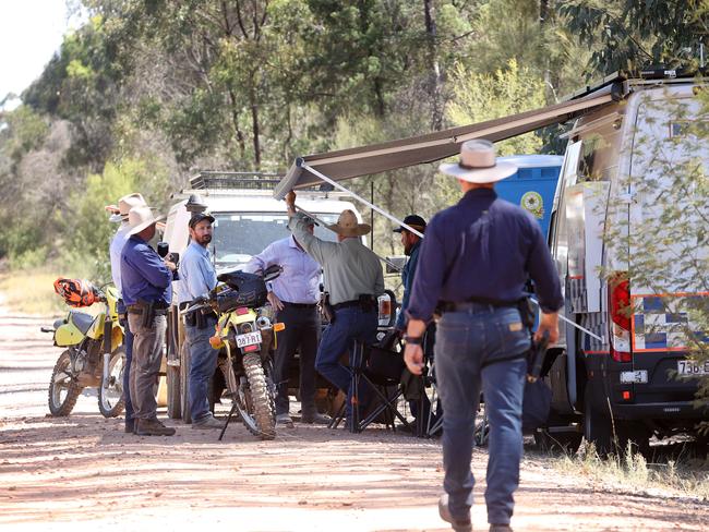 Police on the unsealed Wains Road, Wieambilla, leading to the property where two police officers and a neighbour were killed. Picture: Liam Kidston