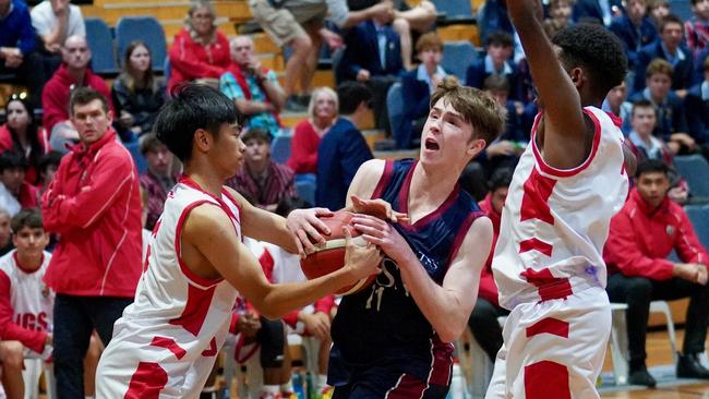 GPS Basketball action: Mikel Tokiyawa and Justin Ventic defend TSS’ Jack Foley. Picture courtesy of Heidi Brinsmead.