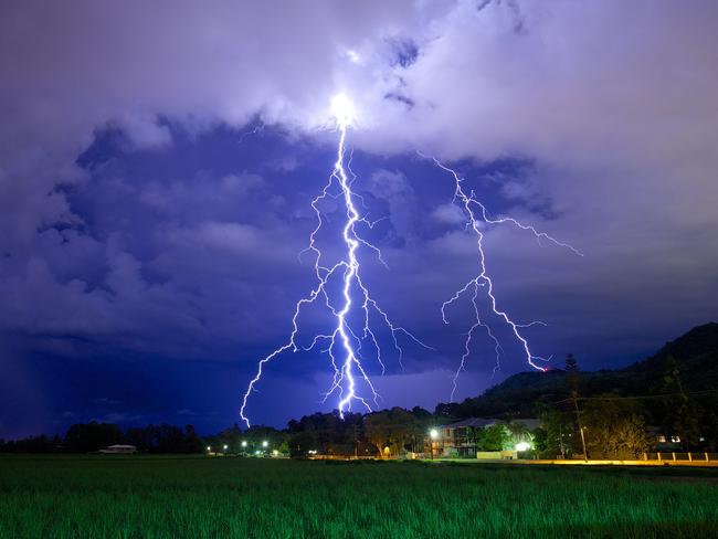 Lightning strikes over sugar cane fields near Cairns. Picture: Marc McCormack.