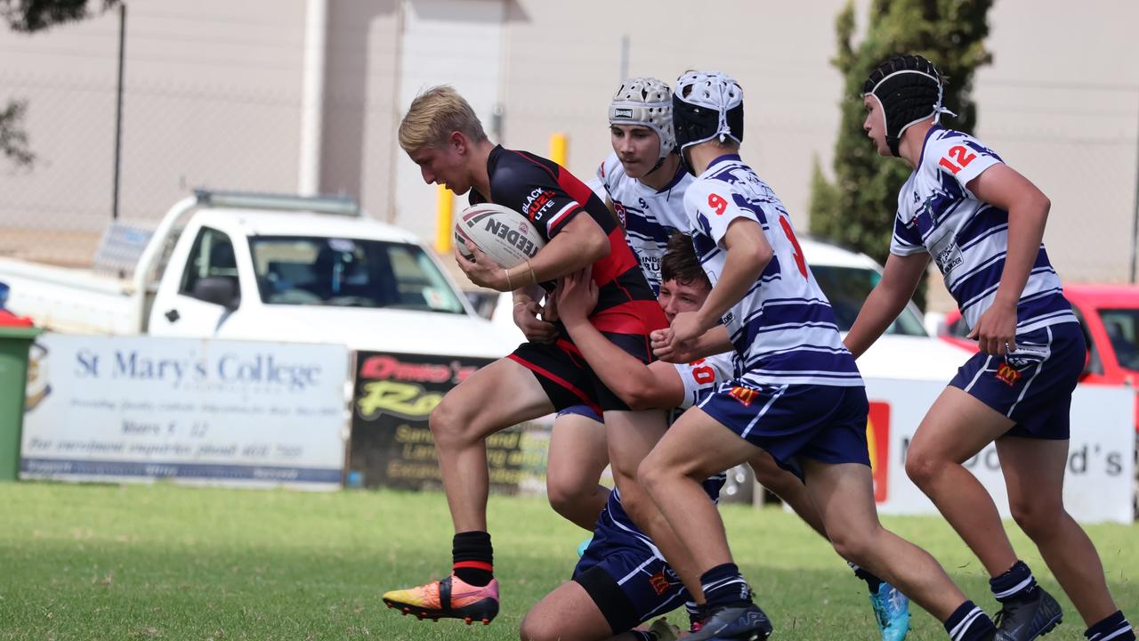 Jackson Winnett attempts to break free of a tackle.